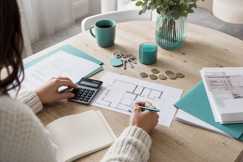 Calcul d'un montant à emprunter pour un achat immobilier sur une table.