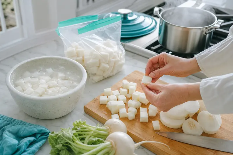 Préparation de navets en dés pour la congélation dans une cuisine lumineuse